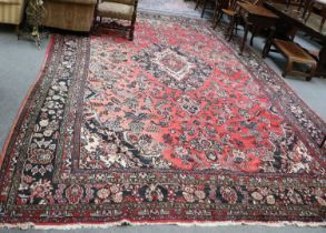 Hamadan Carpet, the faded crimson field of angular vines around and ivory medallion framed by