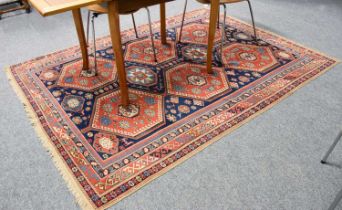 Anatolian Rug, the indigo geometric lattice field with two columns of latch-hook medallions enclosed