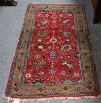 Tabriz Rug, the strawberry field of flowerheads and scrolling vones enclosed by olive green borders,