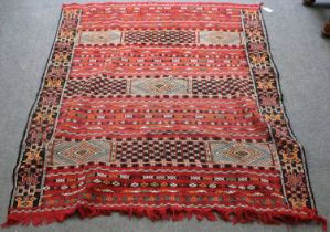 Berber Moroccan Flat Woven Rug, the faded brick red field comprised of panels and bands of geometric