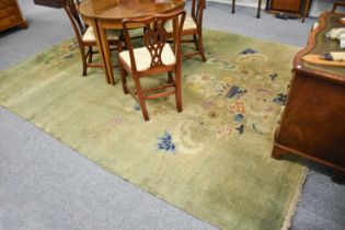 Chinese Art Deco Carpet, the apple green field with an urn issuing flowers, 352cm by 275cm