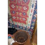 Dhurry rug and a wicker waste basket
