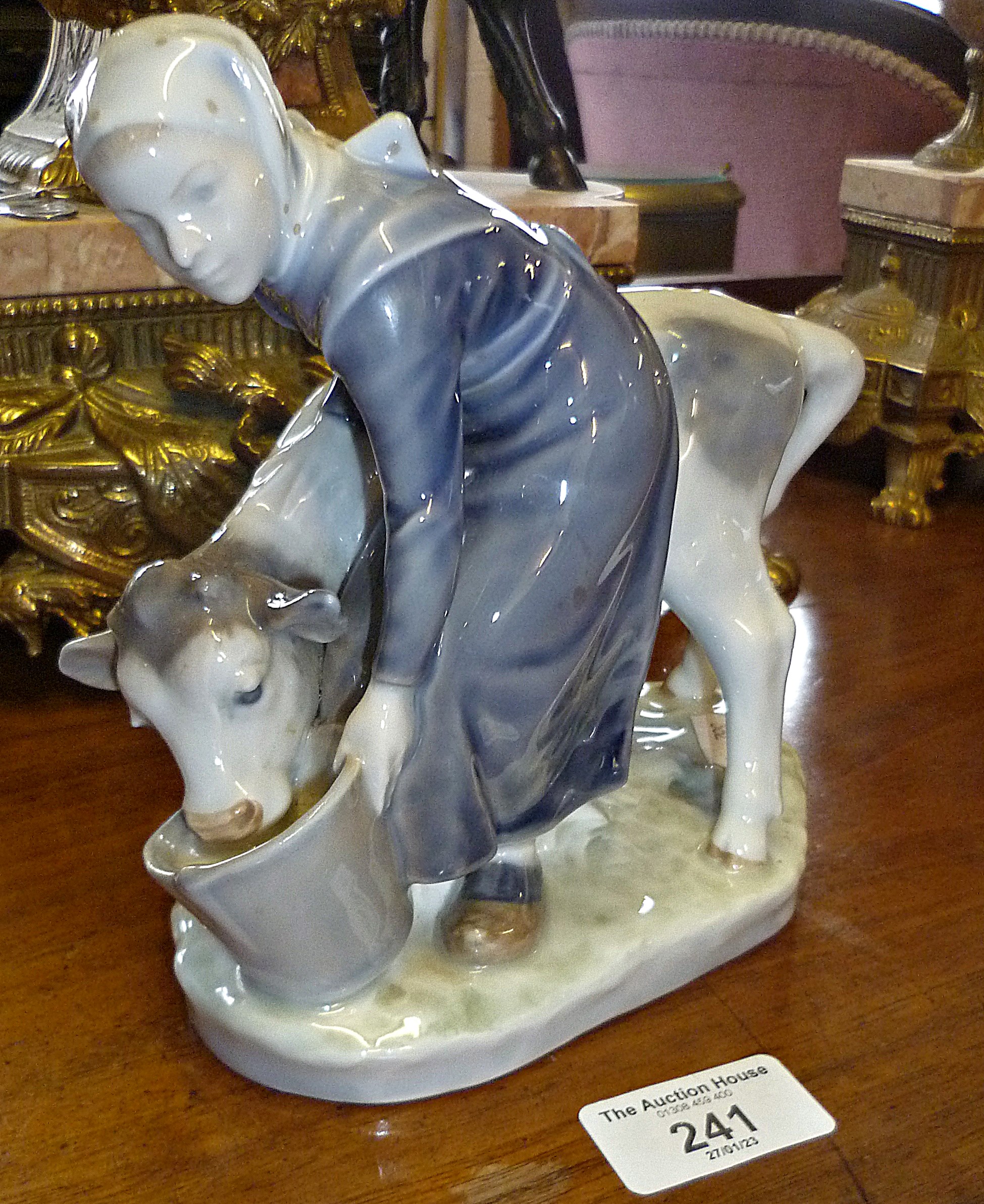 Royal Copenhagen figure of a girl feeding a calf No. 779