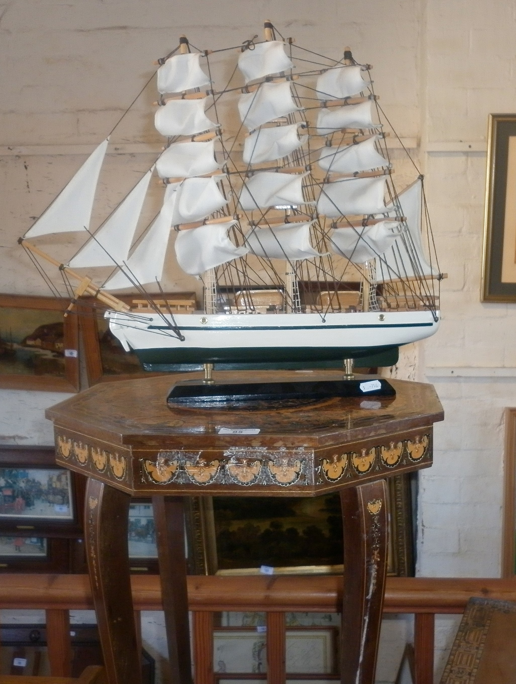 Spanish inlaid musical table and a model sailing ship