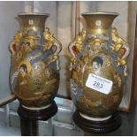 A pair of Satsuma "Thousand Faces" vases with stands, signed, original padded box