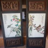 Pair Chinese decorated ceramic panels in carved wood frames