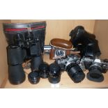 Two Olympus SLR cameras with lenses, another camera and a pair of Prinz binoculars and filters