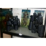 Four pairs of binoculars and three faux stained glass panels