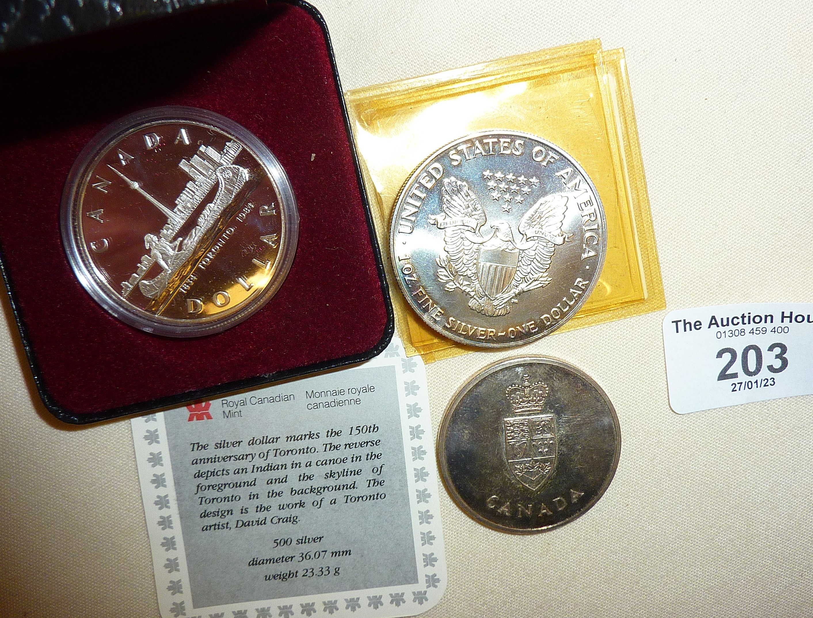 1984 commemorative 500 silver Canadian Dollar in case, 1992 USA silver Liberty dollar, and a 1967