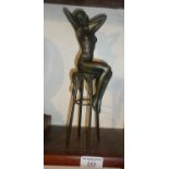 Bronze figure of a nude woman on a bar stool