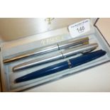 Three fountain pens in a Parker case, a blue Parker 45, a Sheaffer and Waterman's