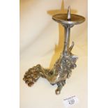 Sculpture of a horned cockerel wearing a tie, formed as a candlestick. Artist's monogram signature