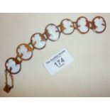 Seven panel shell cameo bracelet set in 9ct rose gold. Approx. 16.5g and 19cm long