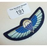 An SAS cloth wings badge, pale blue on a dark felt-type backing