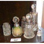 Five glass scent bottles with silver collars