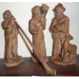 Three early 20th c. Swiss (or ANRI) carved wood figures of peasants, one with alp horn