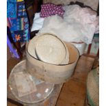 Suitcase of vintage clothing, fabrics and a straw boater in a cardboard hat box