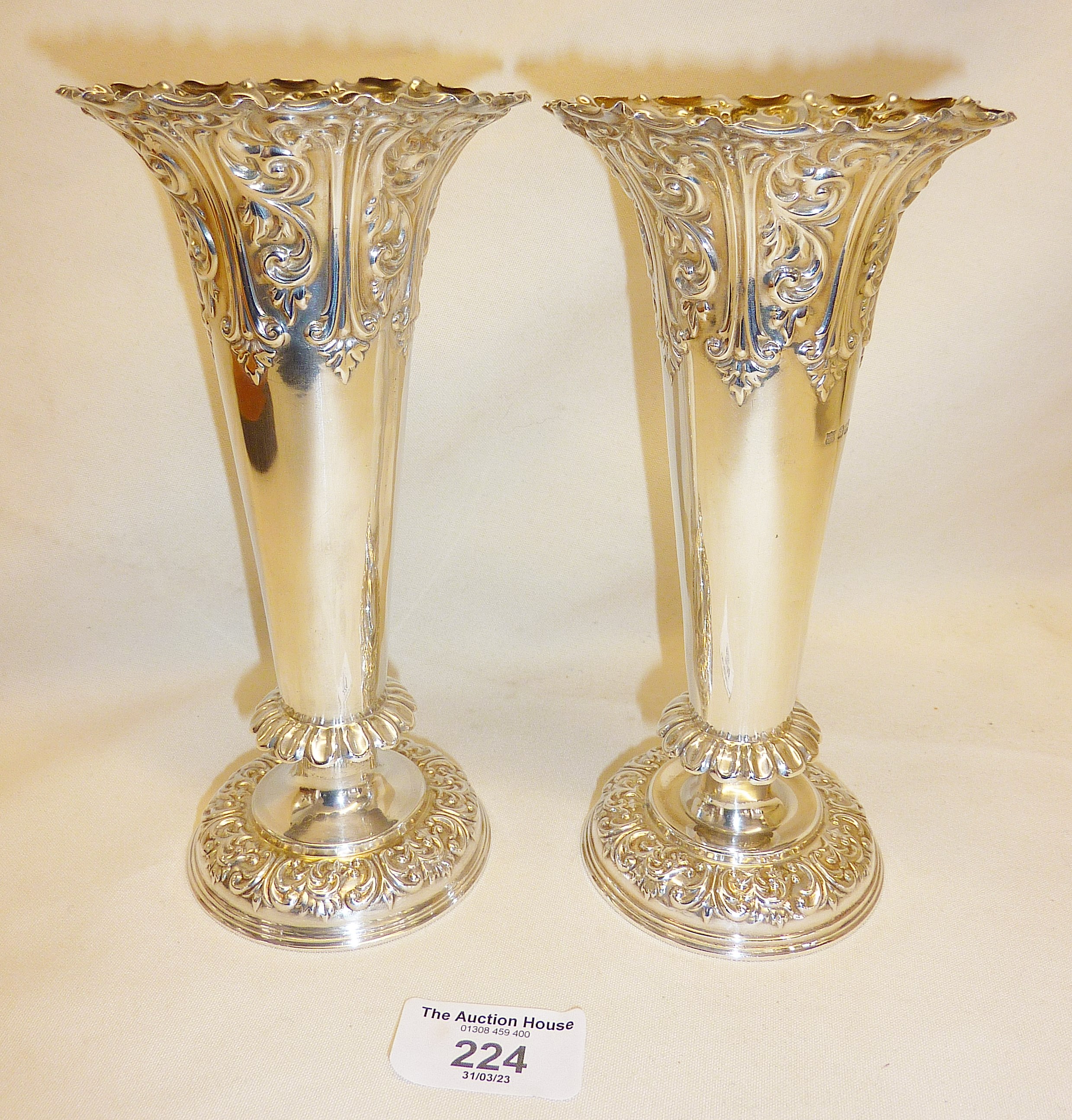 Pair of silver trumpet vases with repoussé decoration. Hallmarked for Sheffield 1898. Approx. height