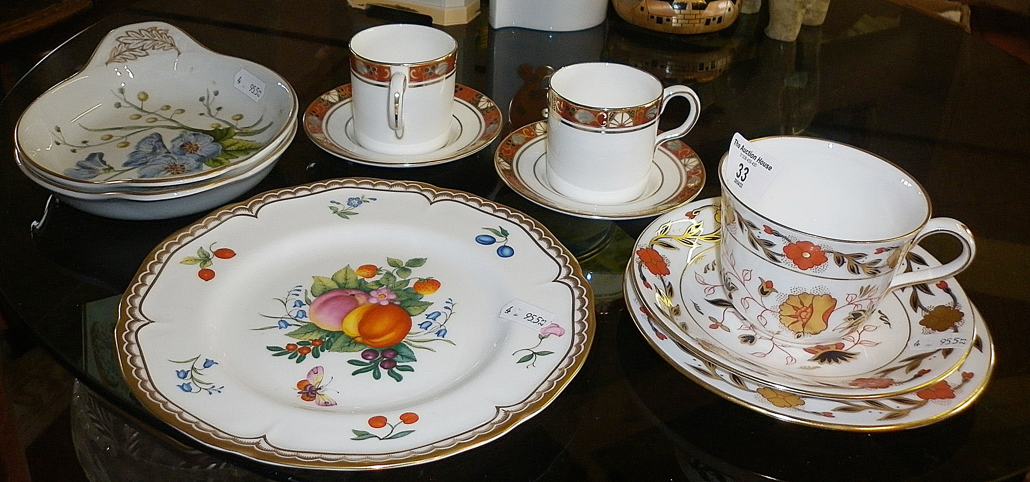 Royal Crown Derby trio, two similar coffee cans with saucers, a Royal Worcester "Gloucester Fruit"