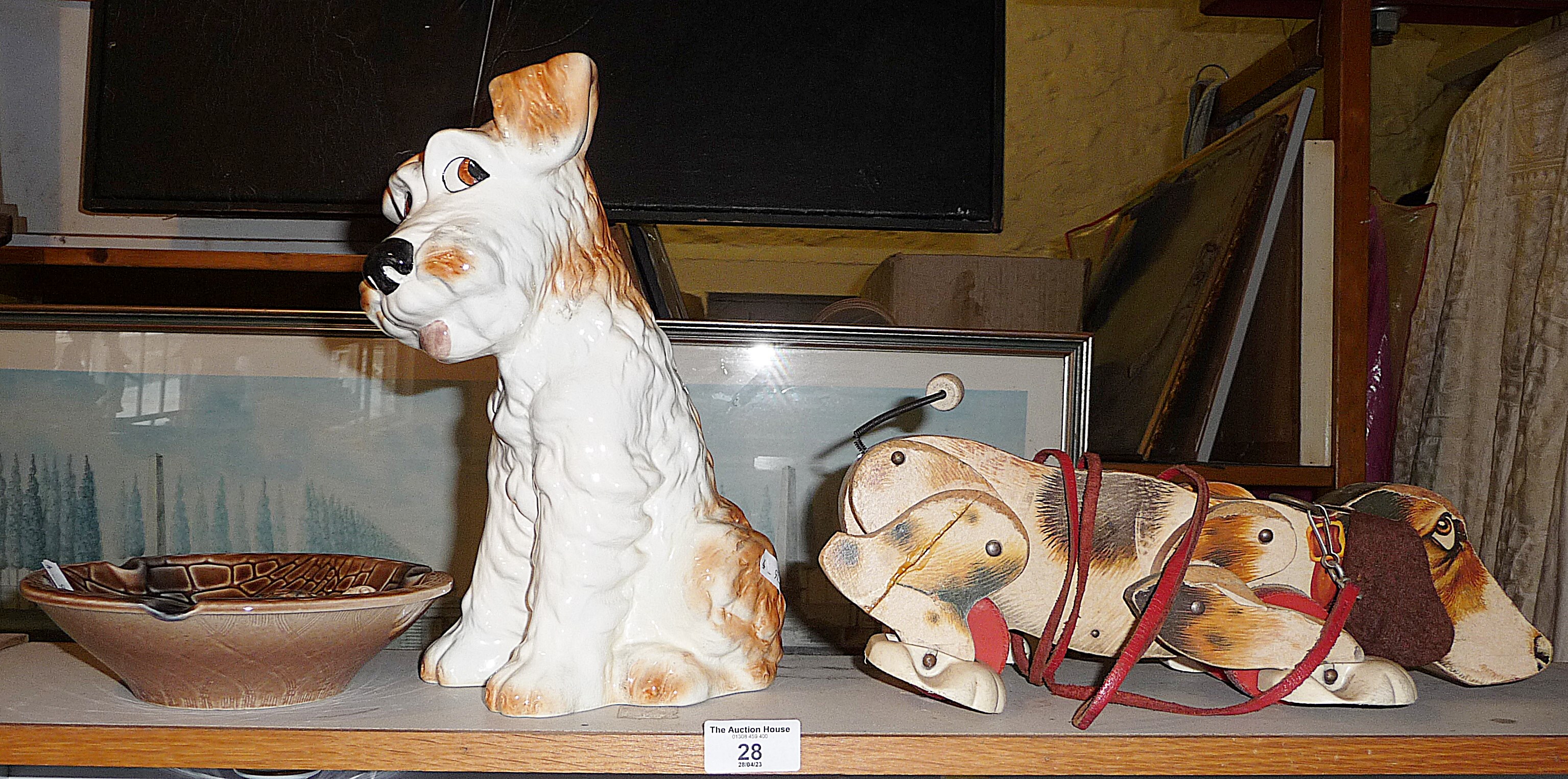 Sylvac pottery large terrier dog, no. 1380, a Wade ashtray and a Snoopy pull-along wooden dog by