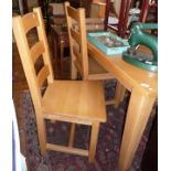 Modern light wood kitchen table and set of four matching chairs