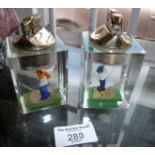 Two mid-century lucite golfers table lighters