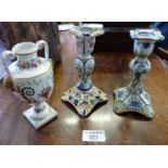 Two Rouen candlesticks and a Continental urn shaped vase