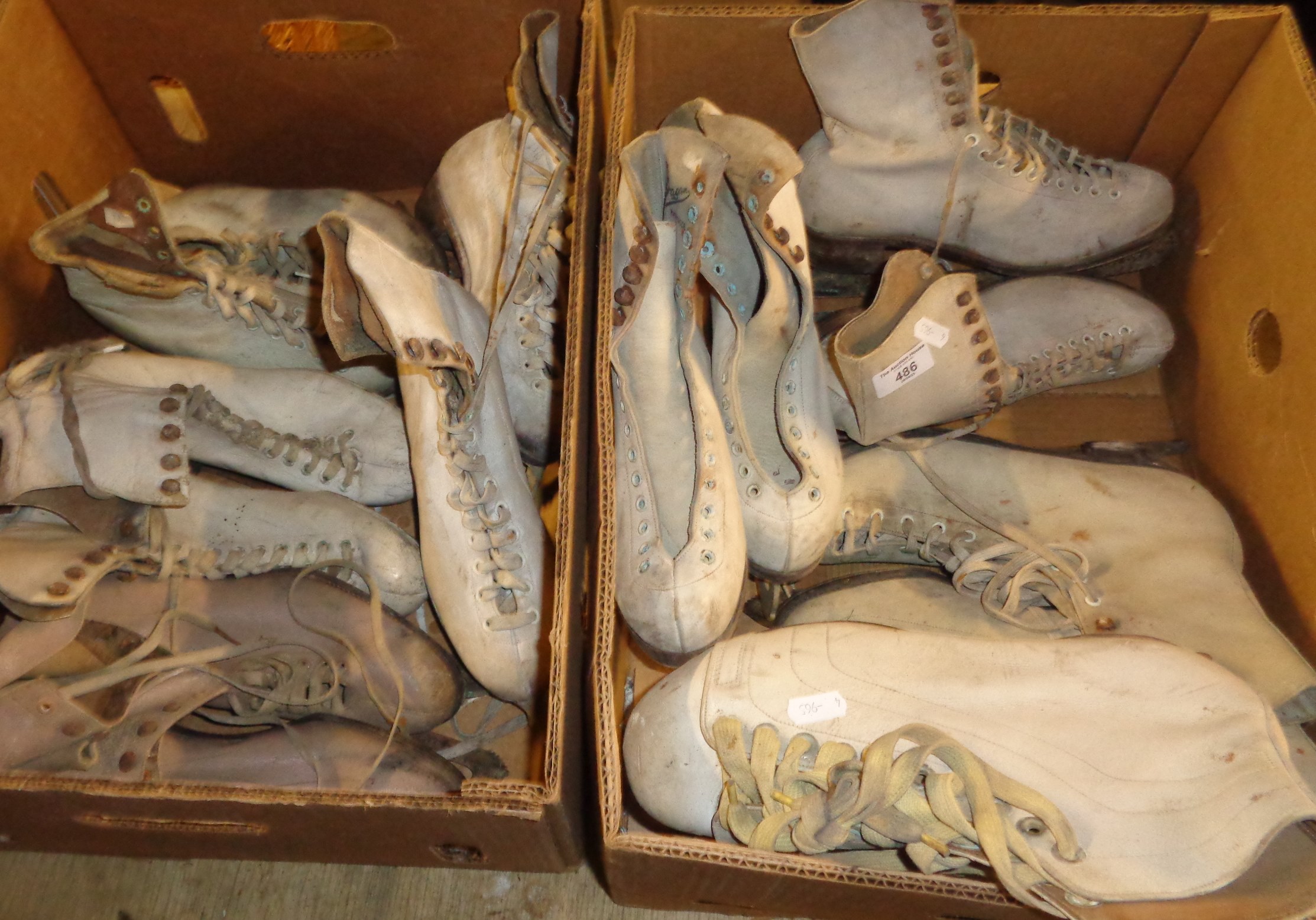 8 pairs of antique leather ice skating shoes and boots