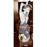 A Grupo Galos porcelain figurine of a semi-clad kneeling woman, 47cm tall, inc. marble plinth