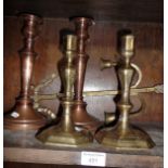 Two pairs of brass and copper candlesticks