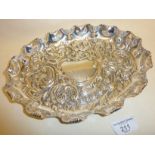 Silver dish with repoussé design and scalloped edge. Approx. 24cm long and 267g. Hallmarked for