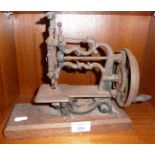 Cast iron child's sewing machine, rusty