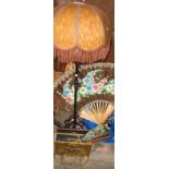 Wrought iron standard lamp with shade, two magazine racks, a large bamboo and painted paper fan