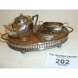 Miniature silver doll's house tea set consisting of tray, teapot, milk jug and sugar bowl.