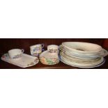 7 various china meat platters and four floral relief sandwich plates with cups and a tray