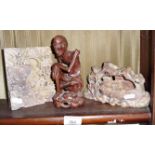 Two Chinese soapstone carvings and a carved hardwood figure of an emaciated but smiling beggar