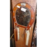Wooden horseshoe wall mirror with clothes brushes