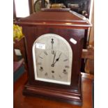 Edwardian mahogany table clock, silver dial, German movement striking on gongs, 18" tall