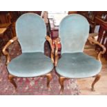 Pair of Edwardian walnut upholstered scroll arm elbow salon chairs