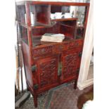 Early 20th c. Chinese carved and red lacquered cabinet having shelves, three drawers and two