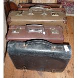 A Home Office leather briefcase stamped E.R., another and two small suitcases