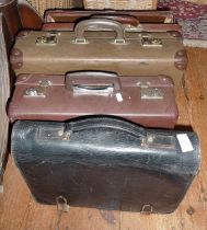 A Home Office leather briefcase stamped E.R., another and two small suitcases