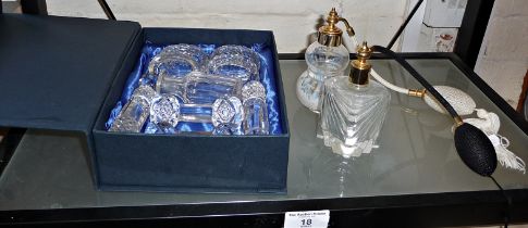 Two glass atomiser perfume bottles and cut glass napkin rings with similar knife rests