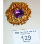 Ornate Victorian gold brooch with purple stone. Approx. weight 17g and 4cm wide. Tests as 9ct +