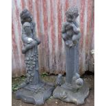 Pair of lacquered stonework garden statues of an imp and a fairly girl on plinths