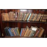 Two shelves of assorted small leather bound books and others