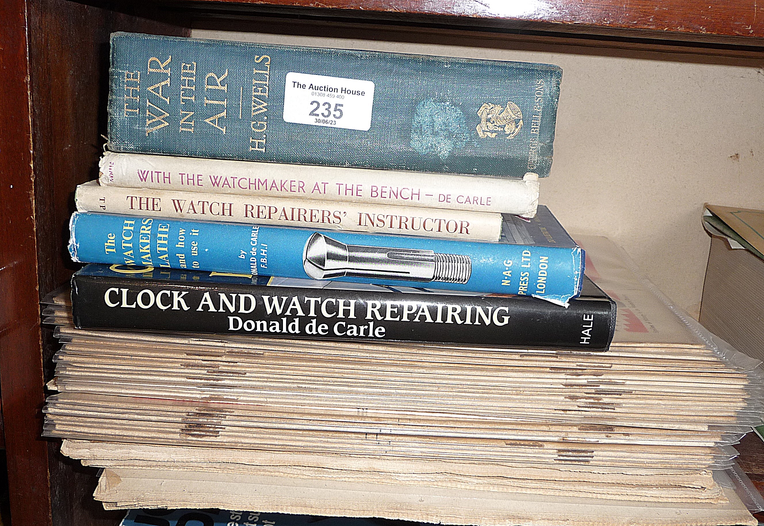 A 1908 edition of H.G. Wells "The War in the Air" together with four various books on watch making