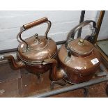 Two Victorian copper kettles and two iron trivets