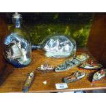 Two ships in Haig whisky bottles and several miniature painted wood tug boats with a similar cargo