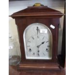 Edwardian mahogany table clock, silver dial, German movement striking on gongs, 18" tall